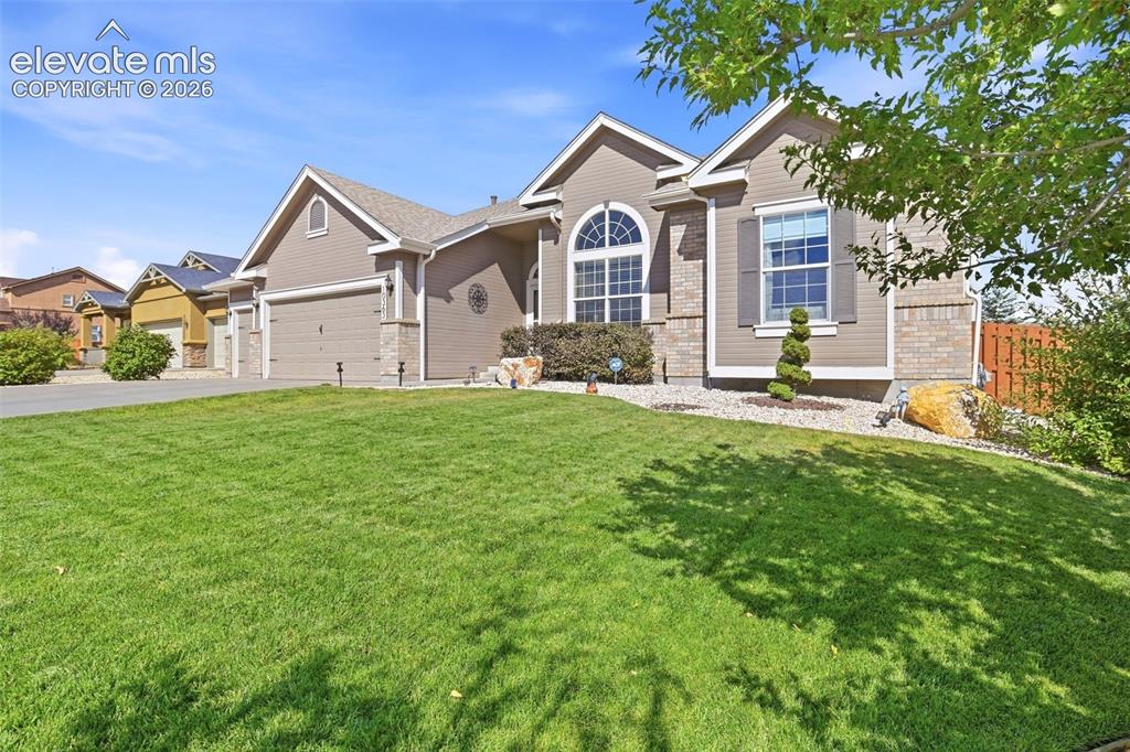 Image 4 of 41: Exterior featuring horizontal siding, stone veneer accents, an arched windo