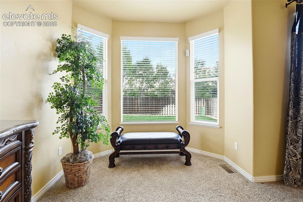 Image 8 of 41: The bay window bump creates a cozy spot to unwind.  Just one of the thought
