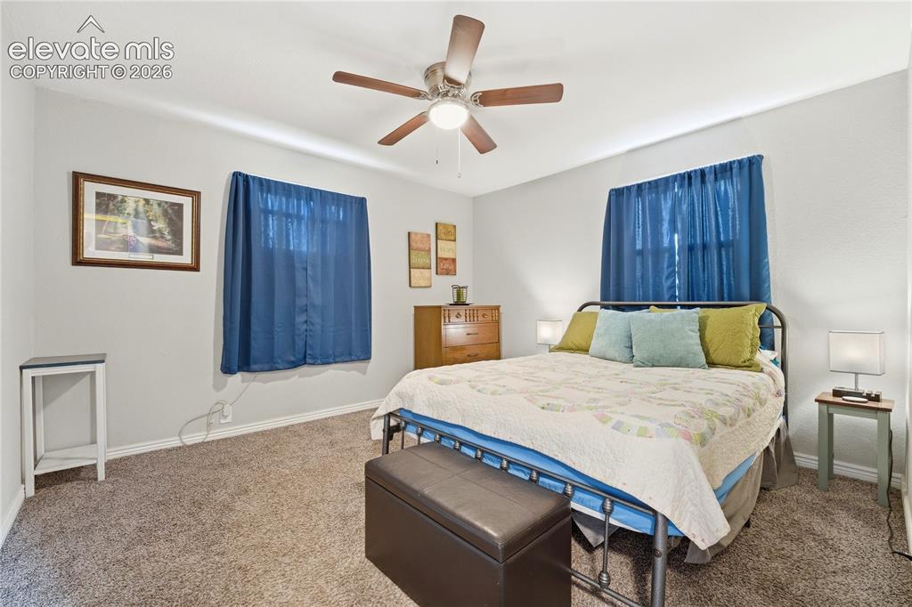 Image 15 of 22: Recessed lighting, ceiling fan with wood-finish blades, and carpeted floori