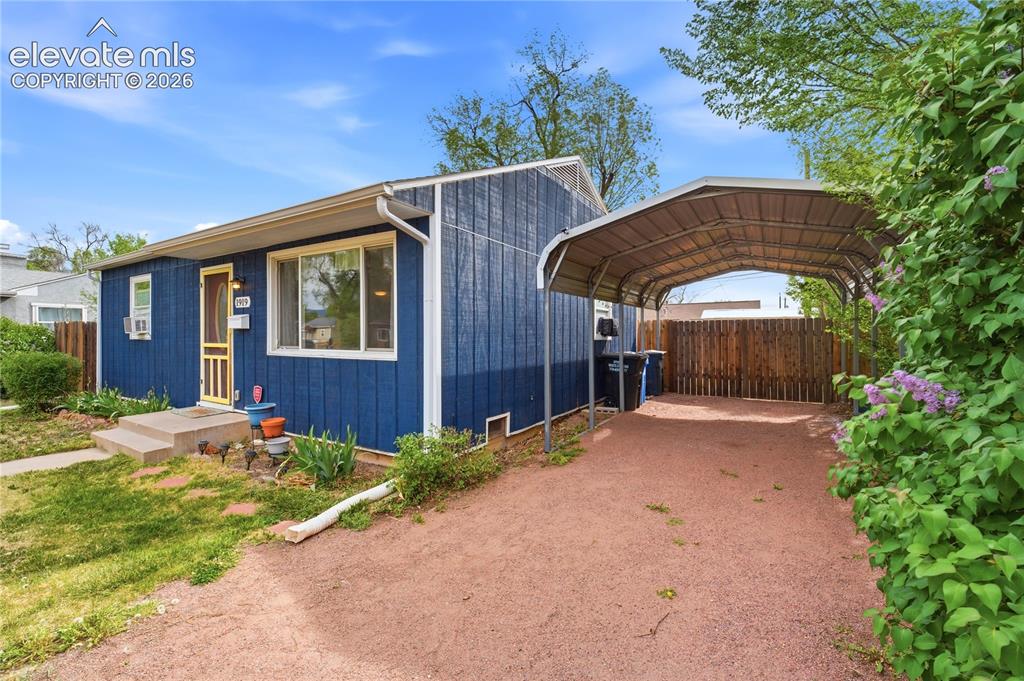 Image 2 of 22: Blue vertical siding exterior with white trim