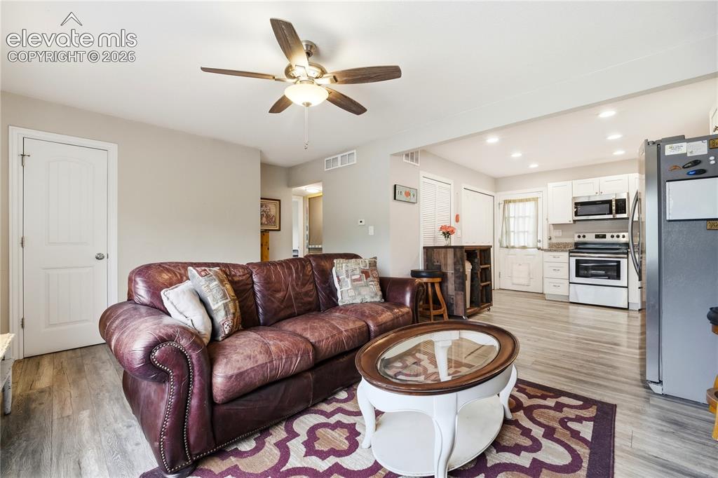 Image 4 of 22: Recessed lighting, wood-finish flooring, ceiling fan with integrated lighti
