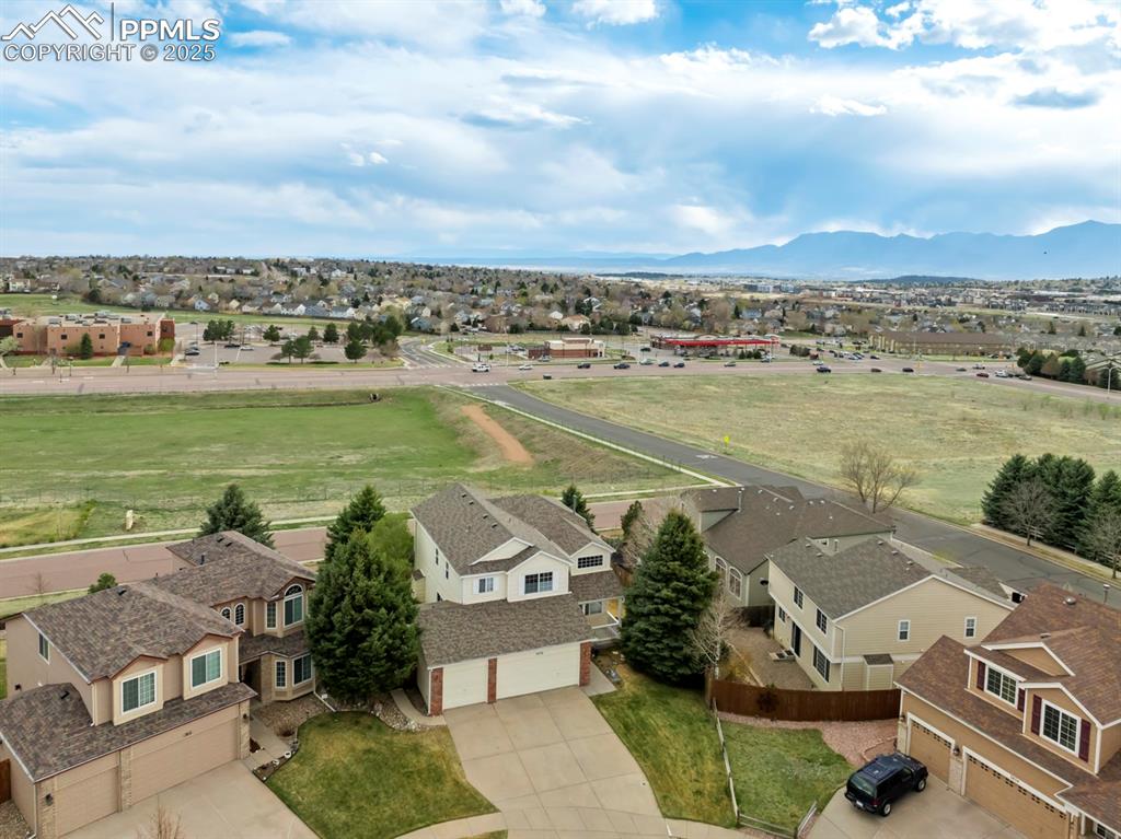 Image 3 of 24: Aerial perspective of suburban area with mountains