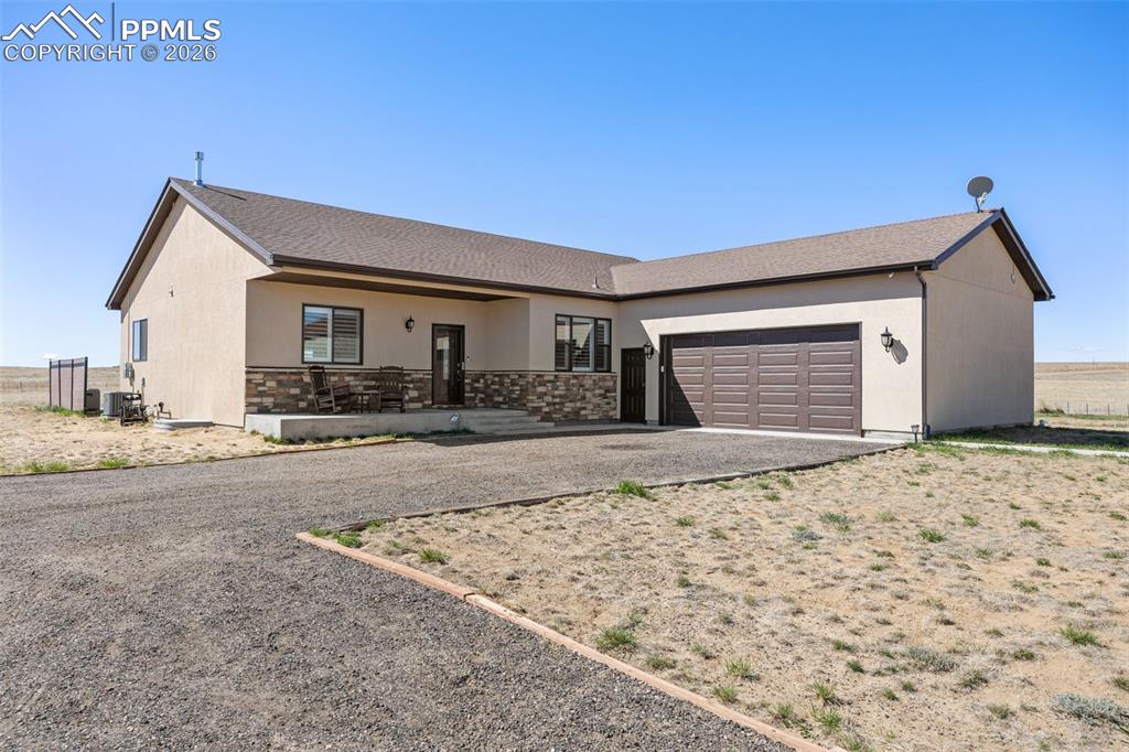 Image 1 of 49: The property features a stucco exterior with a stone accent facade, a cover