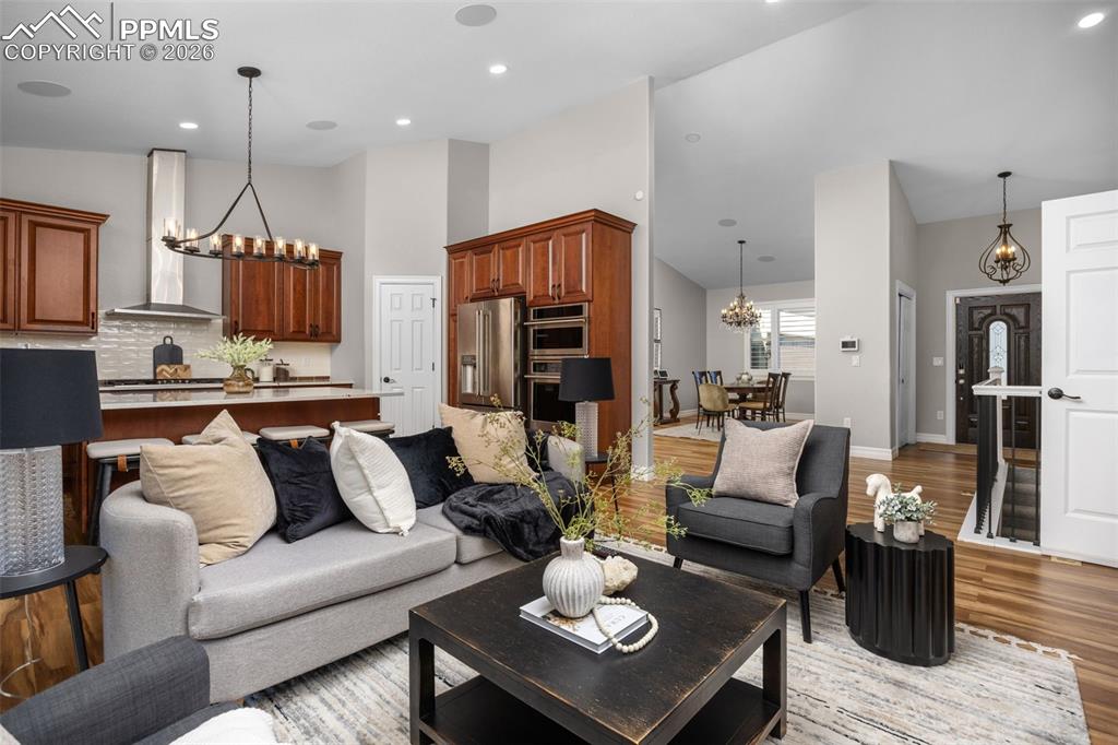 Image 10 of 49: This inviting living area features vaulted ceilings, hardwood flooring, and