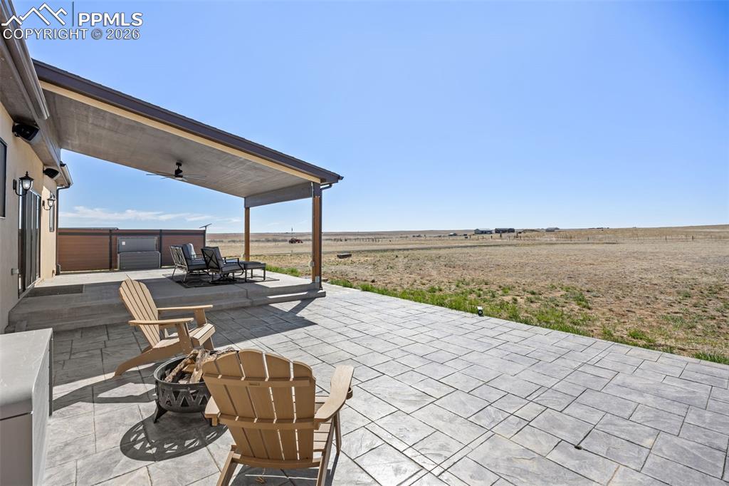 Image 37 of 49: The property features an expansive stamped concrete patio with an attached 
