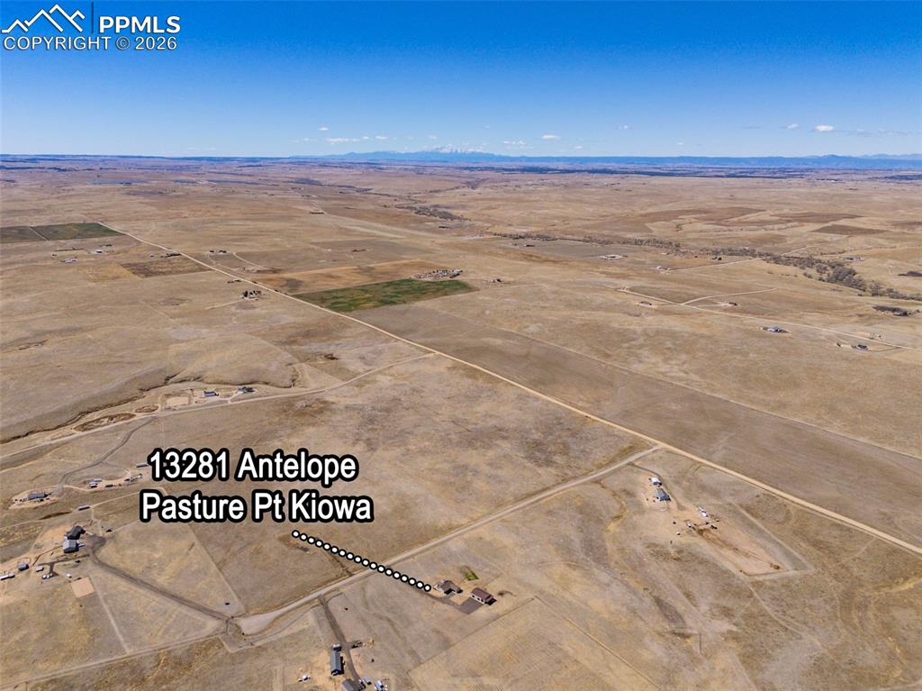 Image 48 of 49: Expansive aerial view of the property and its surrounding open landscape, f