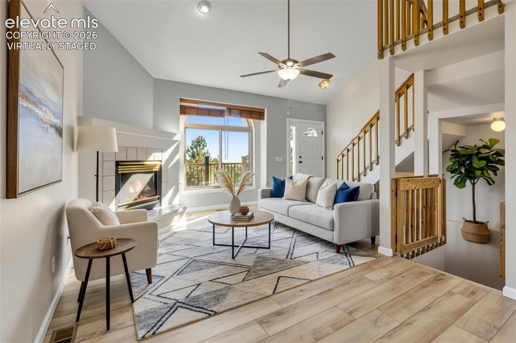 Image 16 of 47: VIRTUALLY STAGED. Welcome inside...Living area with a tiled gas fireplace, 