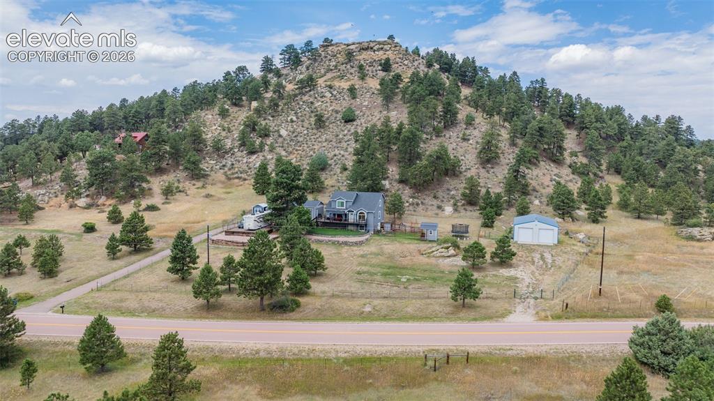 Image 6 of 47: Good aerial overview of the entire property showing the paved driveway, fen