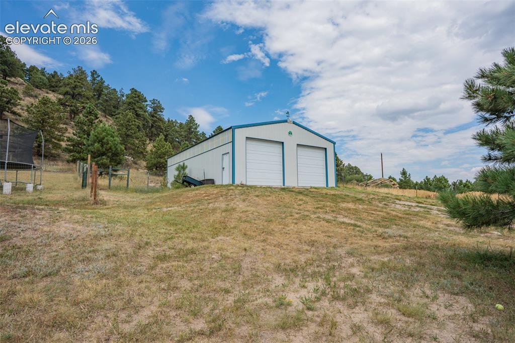 Image 8 of 47: 30x48 Cleary building with 4 inch cement floor; 2 10x10 garage doors.