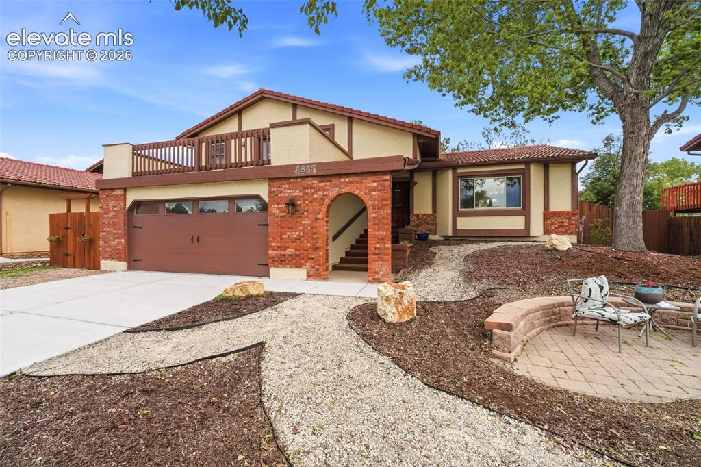 Image 1 of 42: Two-story stucco and brick exterior featuring a tile roof