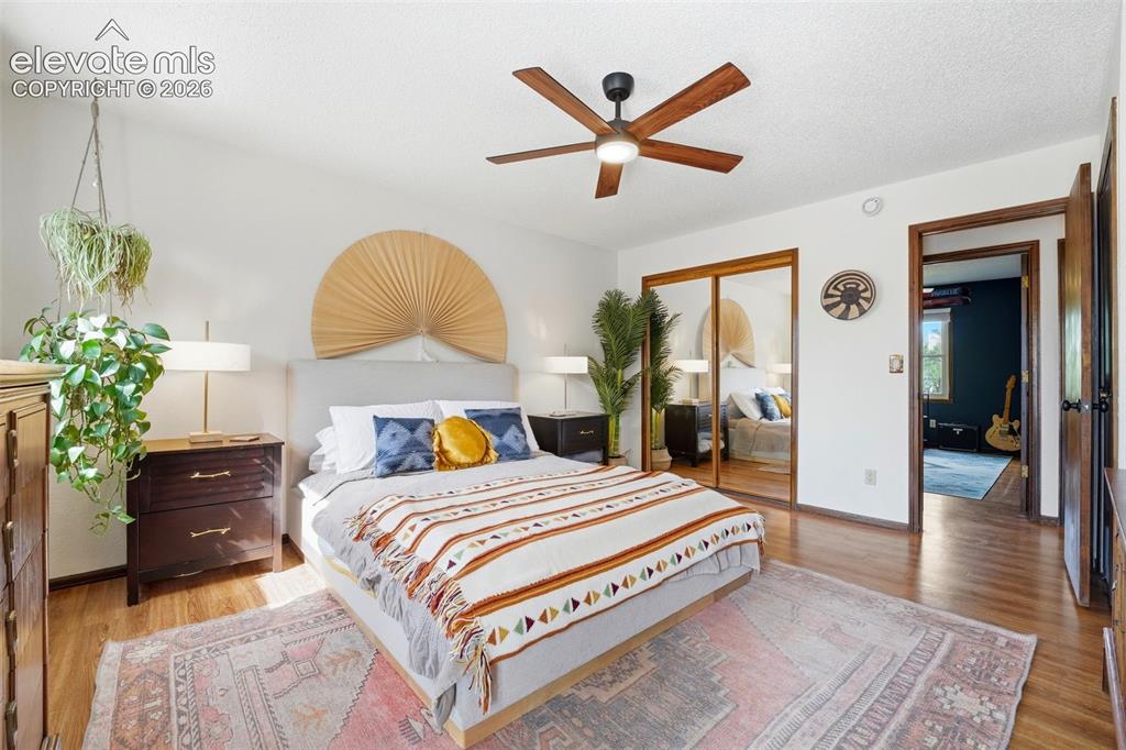 Image 13 of 42: Bedroom featuring wood-finish flooring, a ceiling fan with integrated light