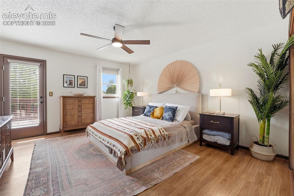 Image 14 of 42: Spacious room featuring wood-finish flooring, a ceiling fan with integrated