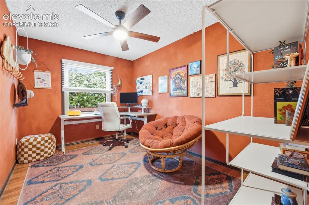 Image 19 of 42: Versatile room featuring a large window with horizontal blinds, a ceiling f