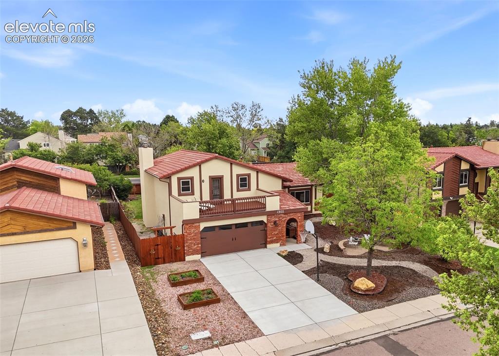 Image 36 of 42: Exterior featuring a terracotta tile roof, stucco and brick facade, a front