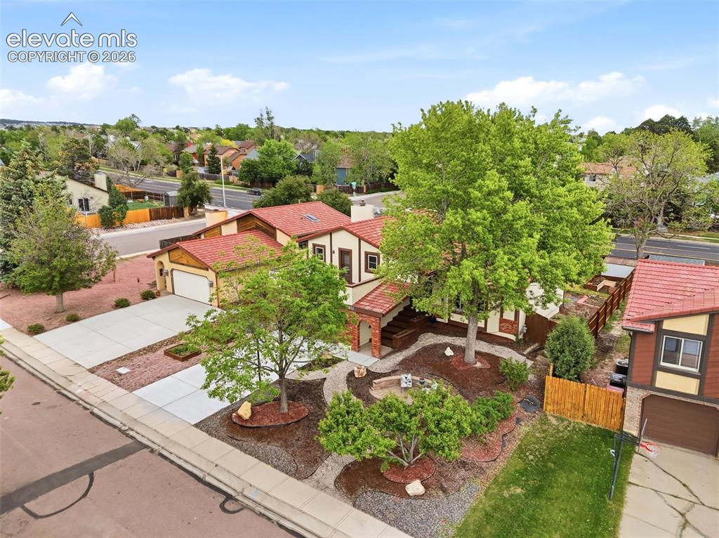 Image 37 of 42: Exterior featuring a terracotta tile roof, two-car garage, concrete drivewa
