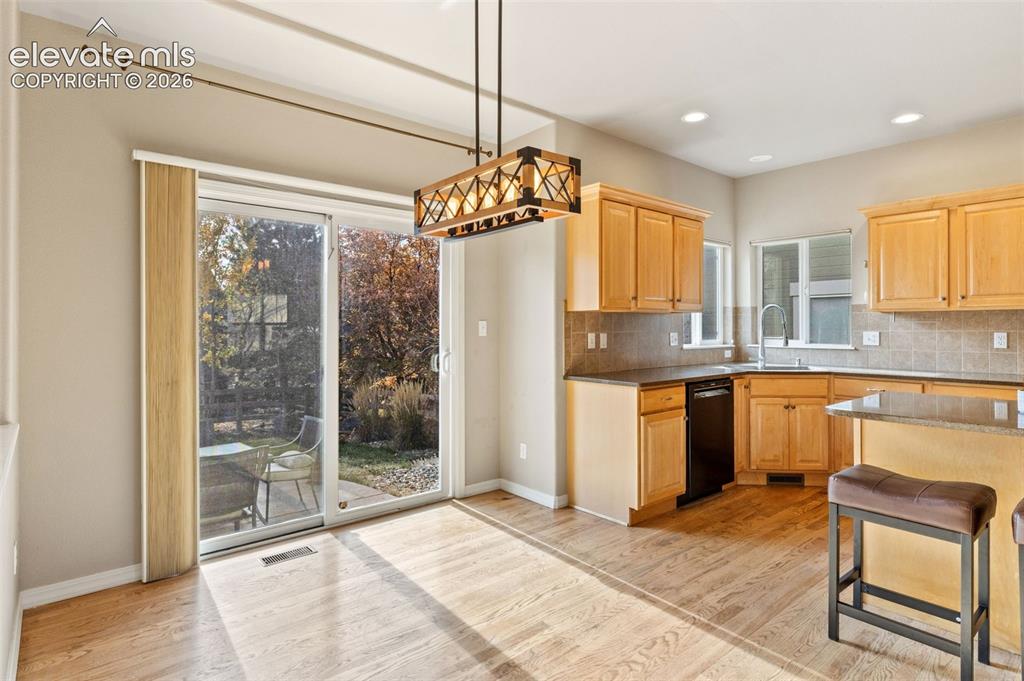 Image 13 of 36: The informal dining area leads to the beautiful outdoor space.