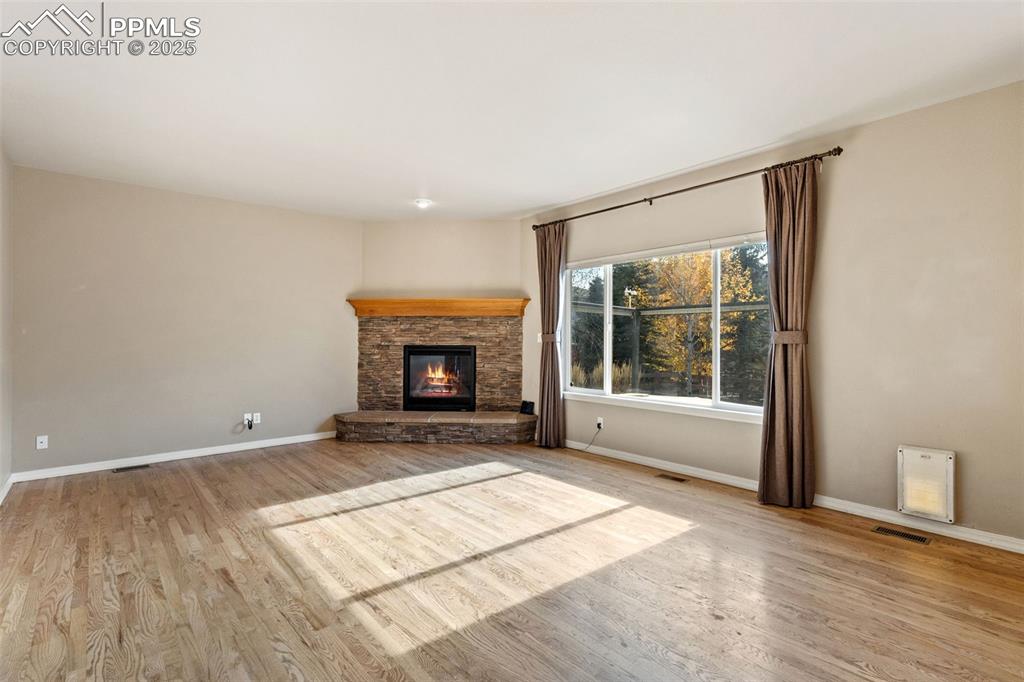 Image 14 of 34: Site finished oak floors grace this wonderful living room that is adjacent