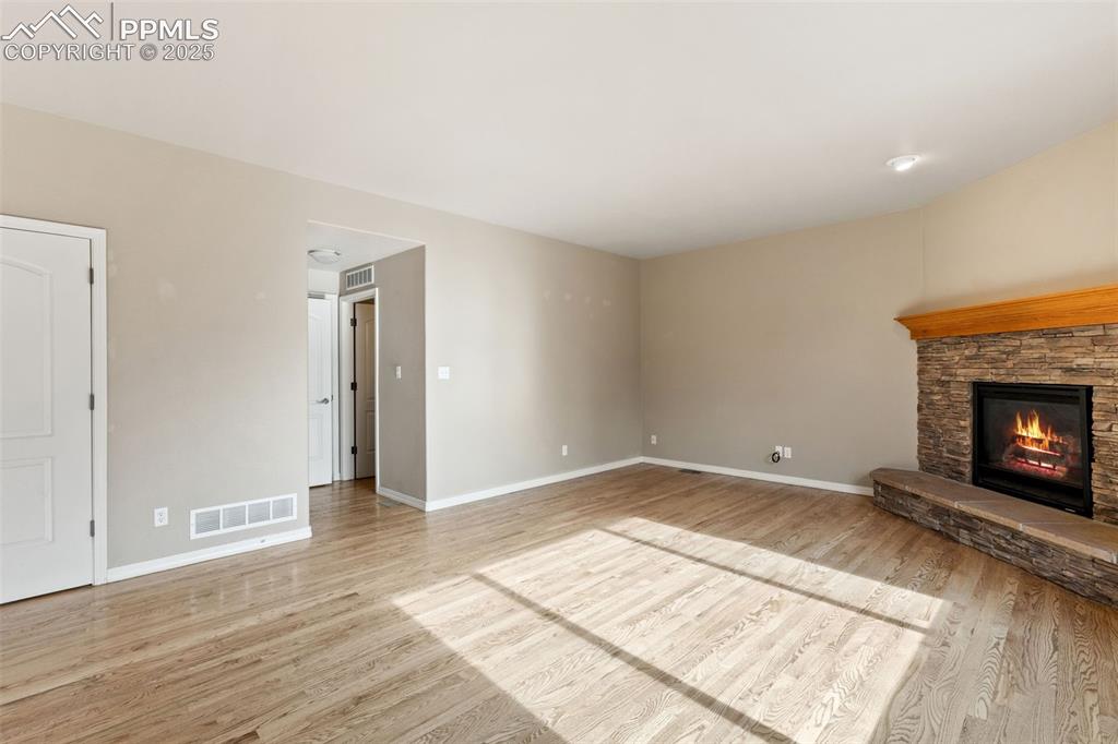 Image 19 of 36: The living room provides access to the garage, powder room and laundry.