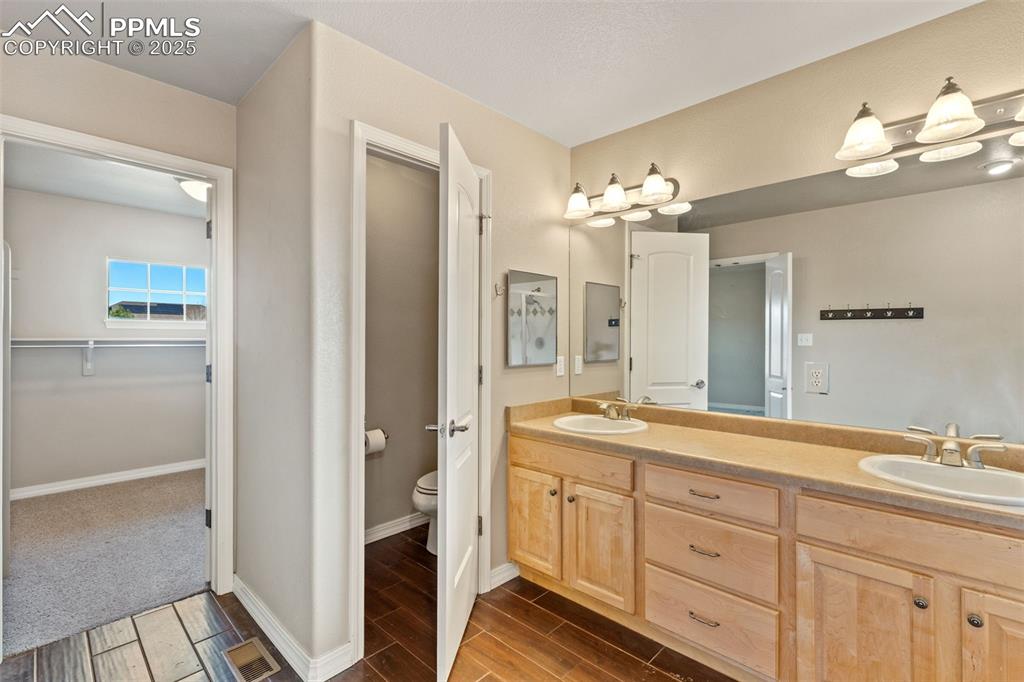 Image 23 of 34: The primary bath offers entry to a huge walk-in closet.