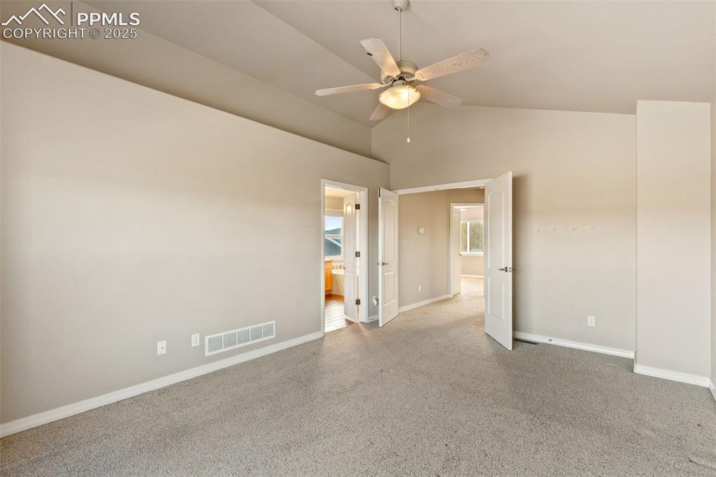 Image 23 of 36: The oversized primary suite is a true retreat with its vaulted ceiling, 5-p