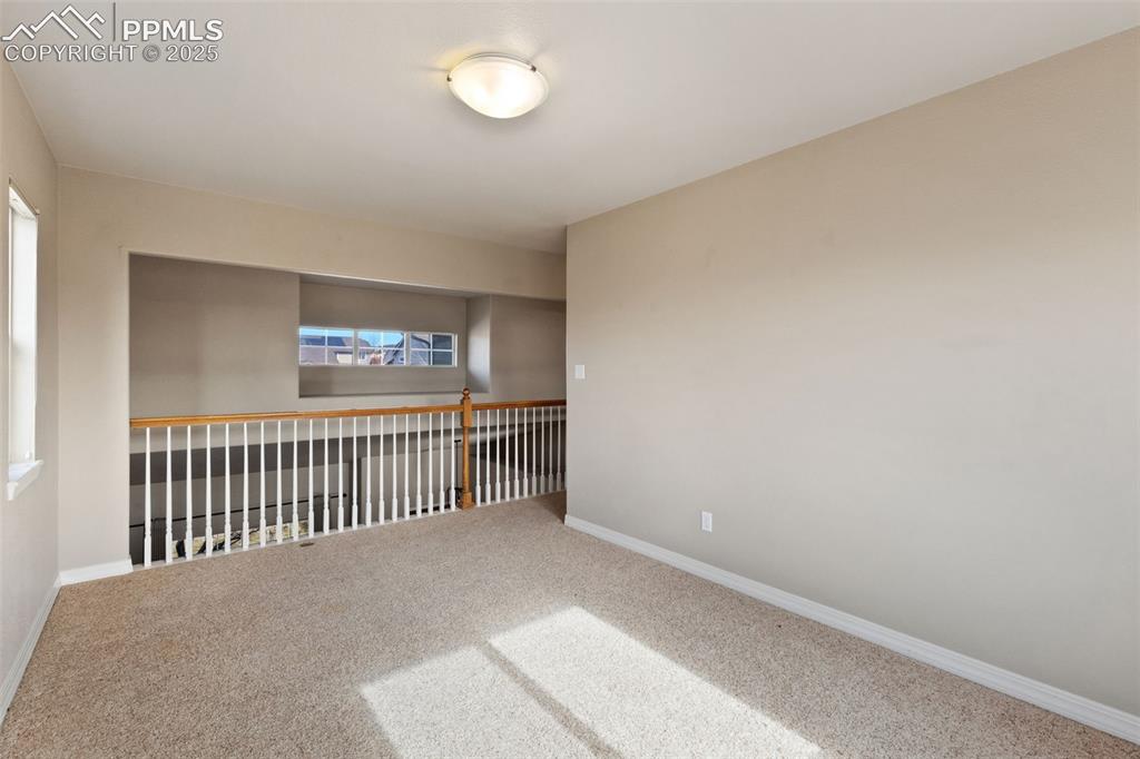 Image 28 of 36: Upper level loft overlooks the entry and dining room. How will you use this
