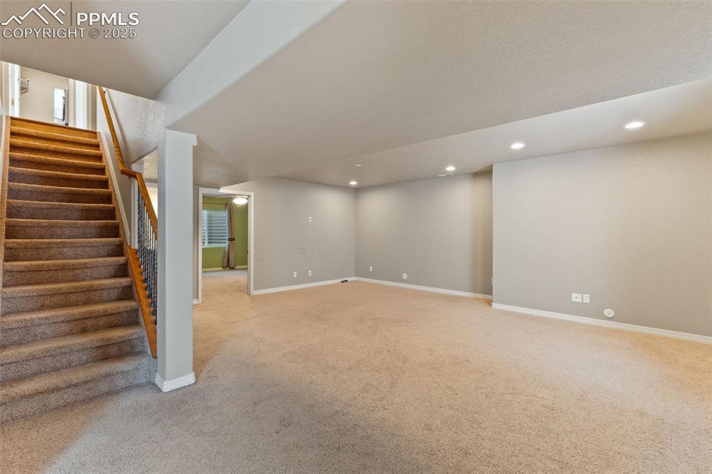 Image 29 of 36: The expansive basement family room has plenty of room for your pool table w