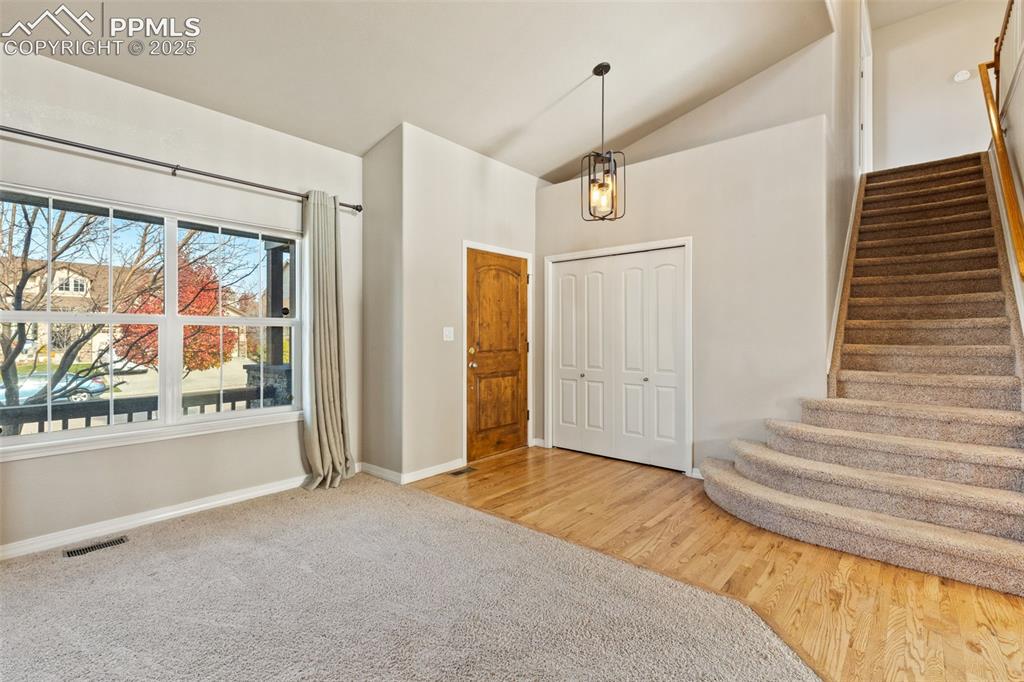 Image 5 of 36: Welcome in! Oak hardwood floors grace the entry and flow into the open livi