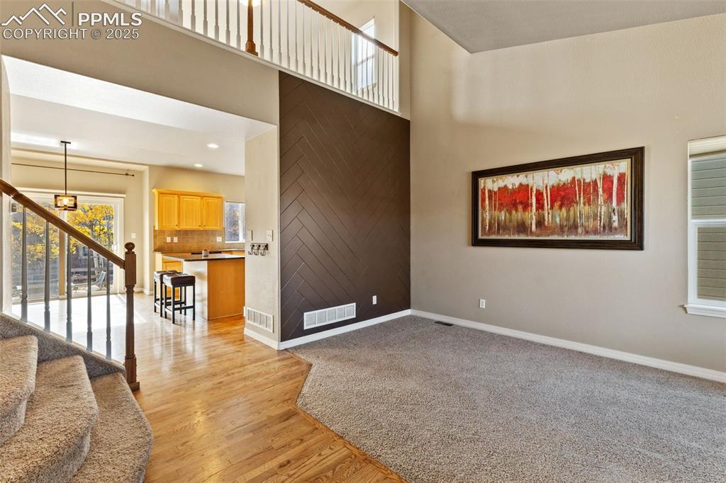 Image 7 of 36: Vaulted ceilings and a view of the open living area greet you as you enter.