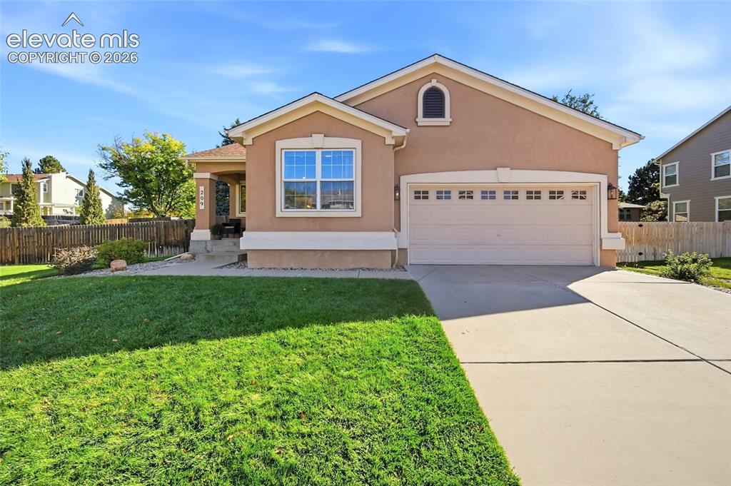 Image 1 of 50: Stucco exterior with a covered porch entry, arched dormer, concrete drivewa