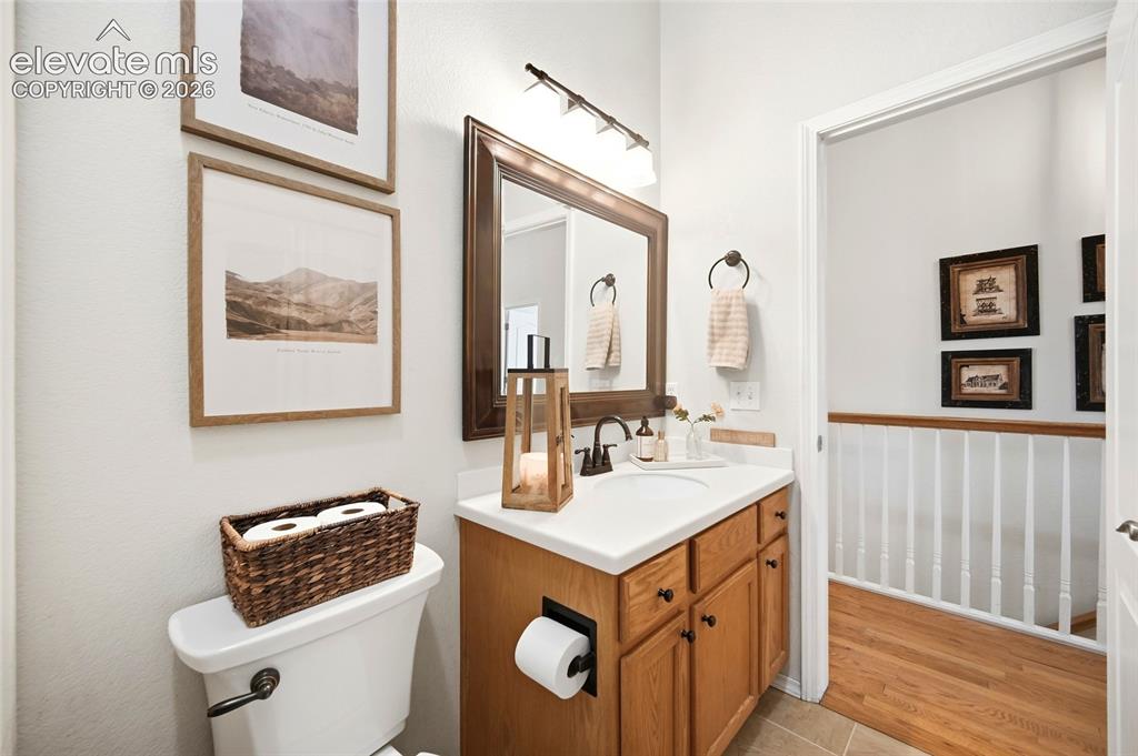 Image 11 of 50: Bathroom vanity with a single basin, light wood-finish cabinetry, and a dar