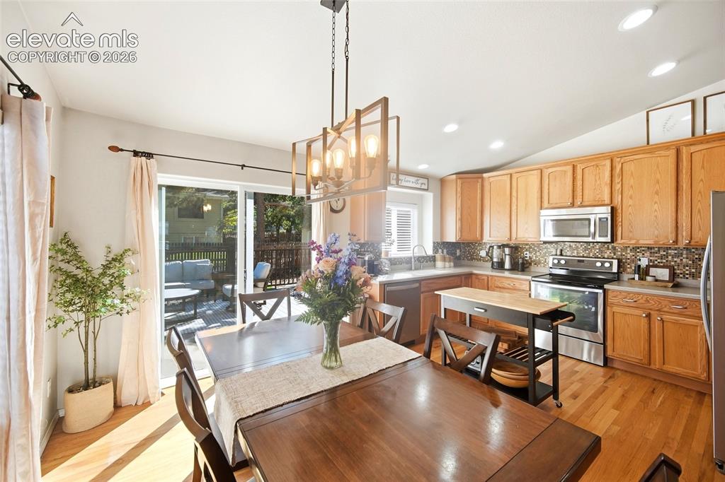 Image 16 of 50: Wood-finish flooring throughout, kitchen with wood cabinetry and stainless