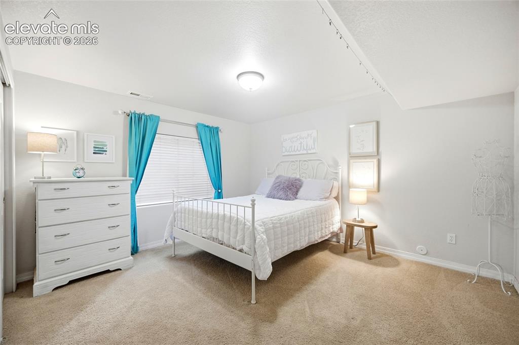 Image 27 of 50: Recessed lighting, window with blinds, carpeted flooring, built-in closet