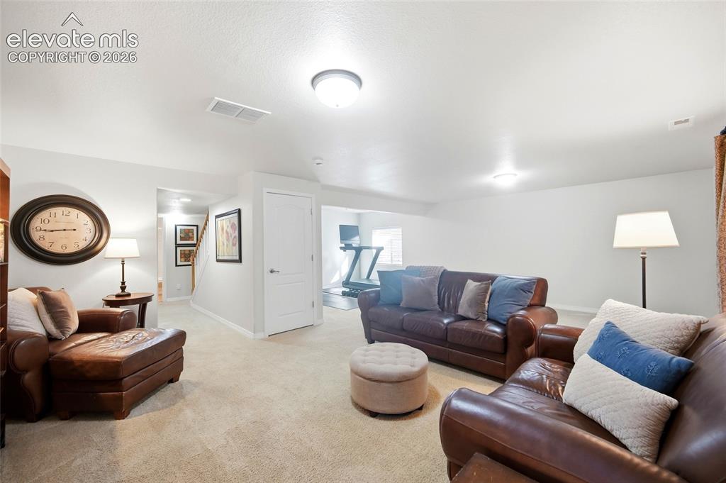 Image 33 of 50: Neutral-toned carpeting spans the floor, complemented by bright white walls