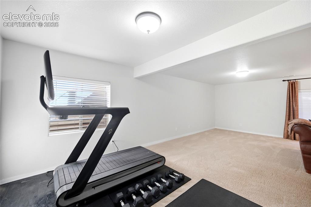 Image 34 of 50: Spacious room with recessed lighting and neutral carpeting