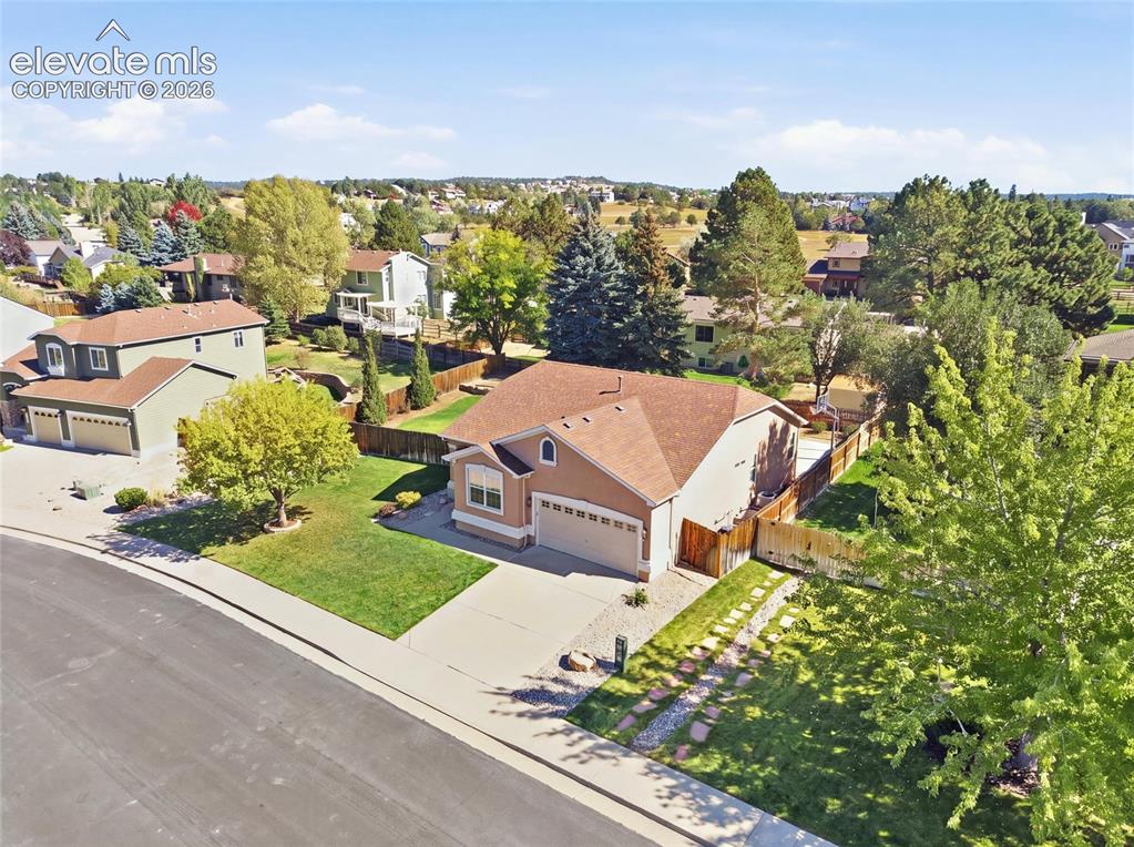 Image 45 of 50: Single-story residence with a two-car garage, concrete driveway, and a fenc