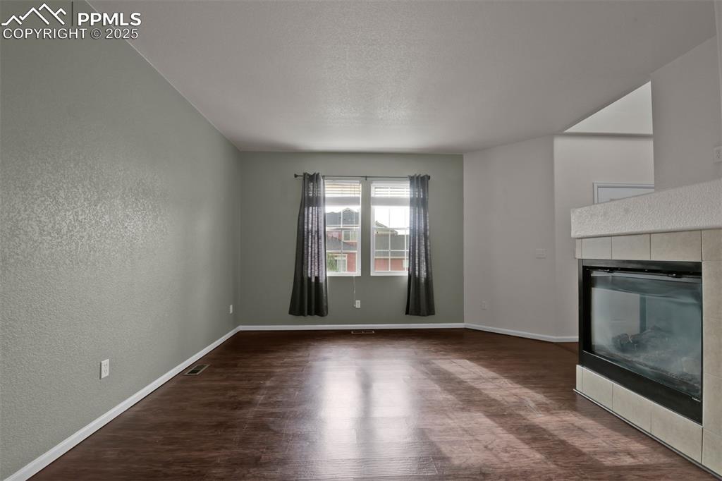 Image 11 of 38: View from kitchen:Combined living/dining room featuring dark wood-style flo