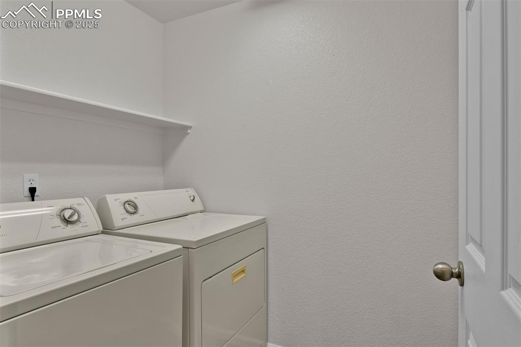 Image 16 of 38: Laundry area with separate washer and dryer