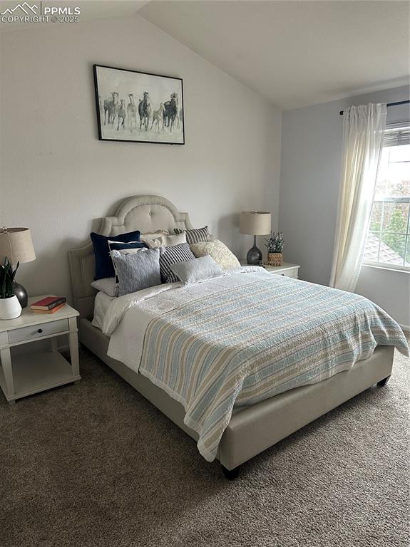 Image 20 of 38: Bedroom featuring carpet and vaulted ceiling