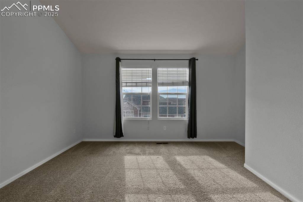 Image 22 of 38: Primary room featuring light colored carpet and baseboards