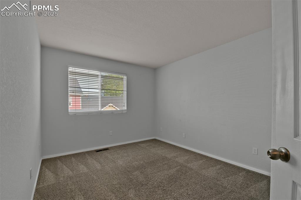Image 27 of 38: North facing 2nd bedroom with sliding door closet