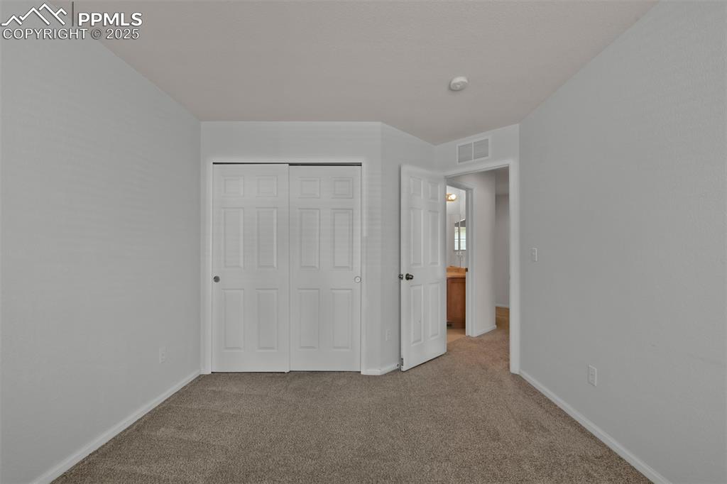 Image 28 of 38: Unfurnished bedroom featuring carpet floors and a closet
