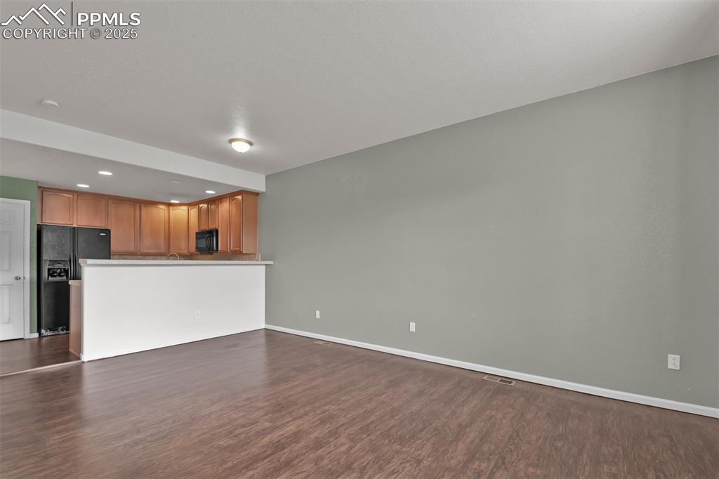 Image 5 of 38: Dining area featuring dark wood-style flooring and recessed lighting with a