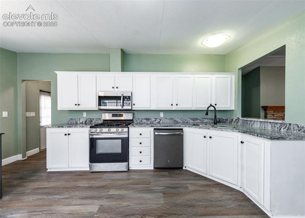 Image 11 of 26: Kitchen with lots of cabinets