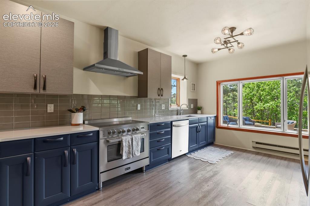 Image 11 of 49: Verona induction range and stainless appliances complete the kitchen.
