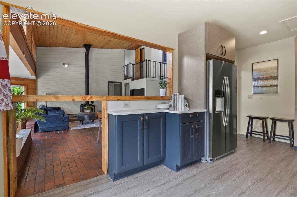 Image 12 of 49: Silestone quartz counters and custom Thomasville cabinetry.