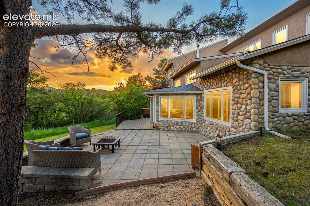 Image 3 of 49: Expansive deck overlooking peaceful natural surroundings.