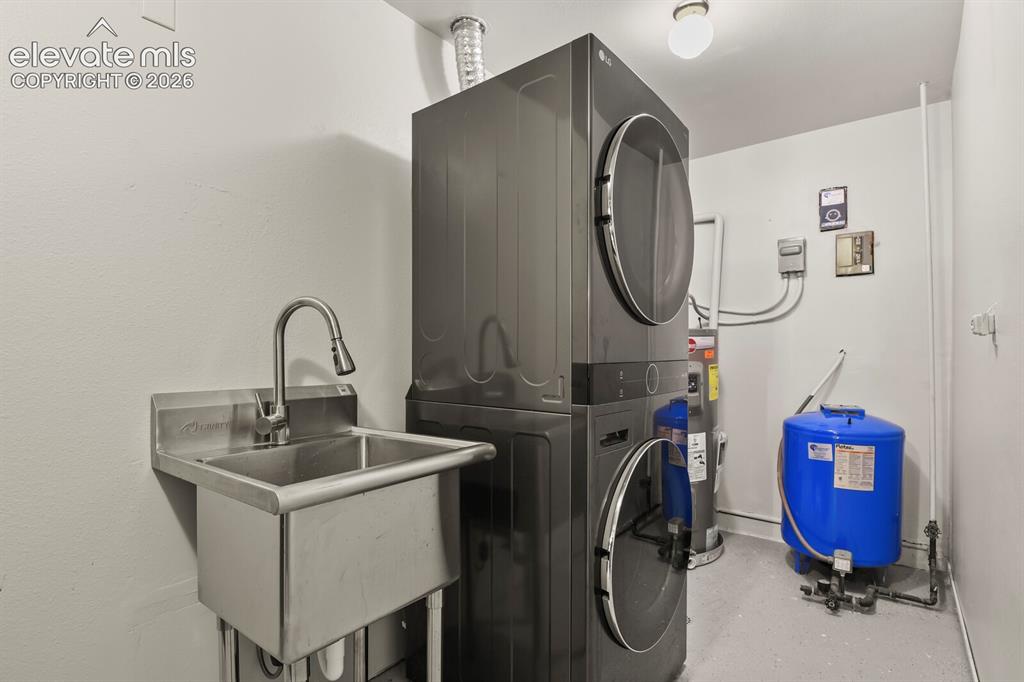 Image 30 of 49: Convenient lower-level laundry room with extra storage.