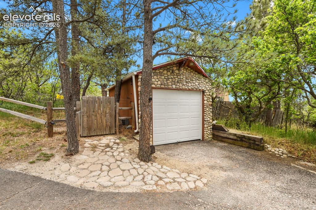 Image 41 of 49: Detached garage with convenient storage and workshop potential.