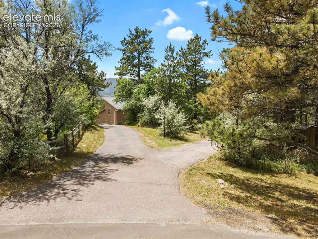 Image 42 of 49: Private driveway welcomes you to this secluded Colorado retreat.