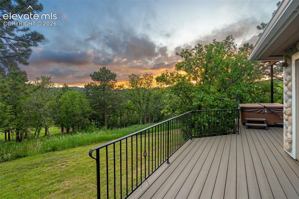 Image 5 of 49: Expansive outdoor living spaces with deck and scenic views.